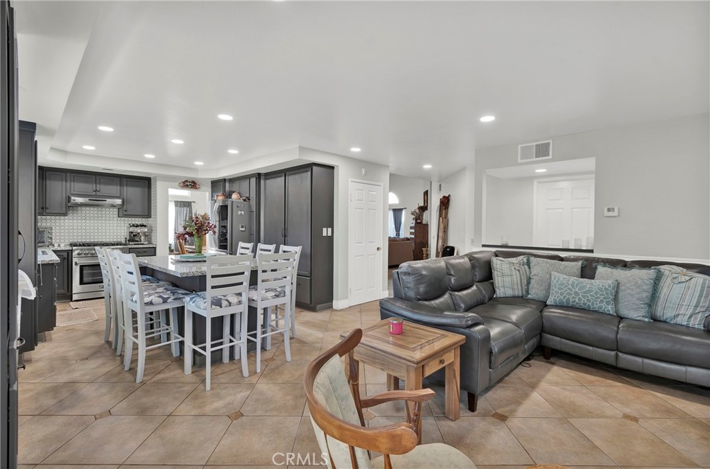 3350 May Court Riverside, CA 92503 - Photo 35 of 55 a living room with furniture and a dining table with kitchen view