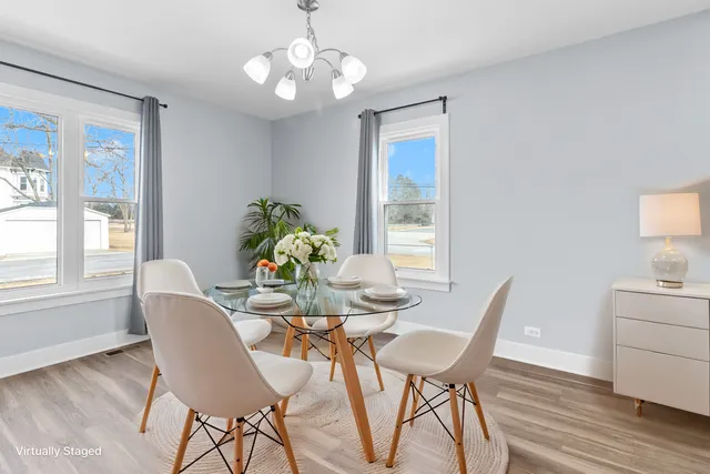 a view of a dining room with furniture wooden floor and chandelier
