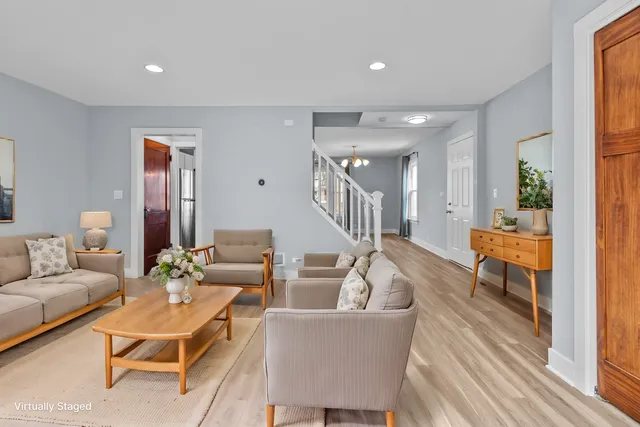 a living room with furniture and a wooden floor