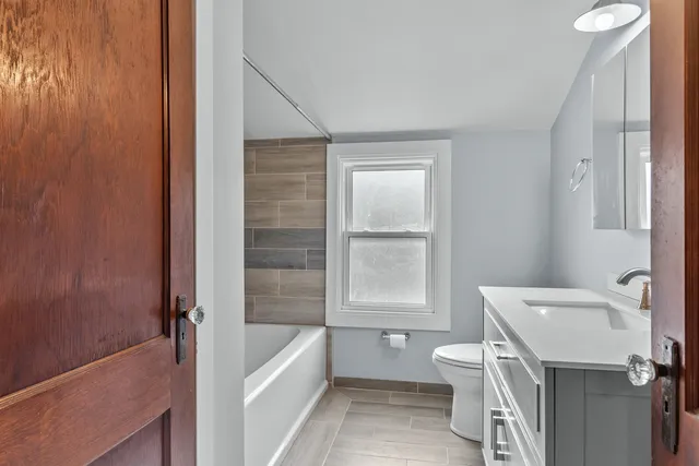 a bathroom with a sink a toilet and tub