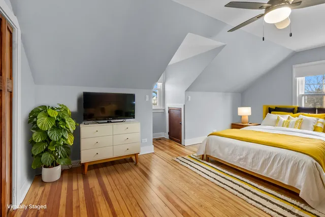 a bedroom with a bed and flat screen tv