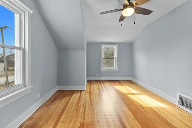 a view of a livingroom with wooden floor and a window