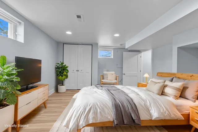 a bedroom with a large bed and a flat screen tv