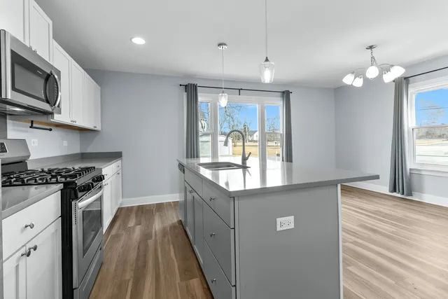 a kitchen with stainless steel appliances granite countertop a stove and a sink