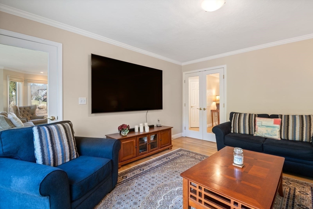 101 Tussock Brook Road, Unit 101 Duxbury, MA 02332 - Photo 11 of 38 a living room with furniture and a flat screen tv