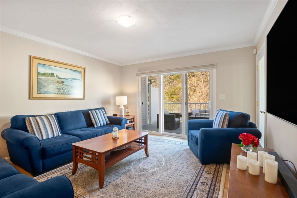 101 Tussock Brook Road, Unit 101 Duxbury, MA 02332 - Photo 12 of 38 a living room with furniture and a flat screen tv