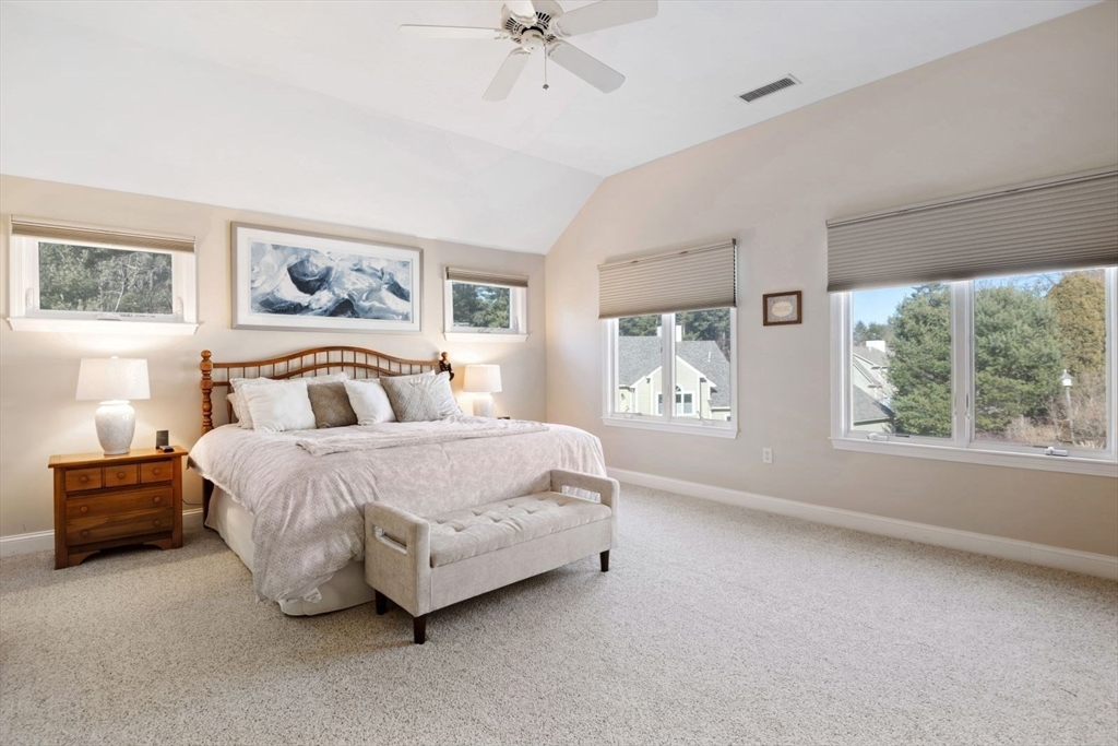 101 Tussock Brook Road, Unit 101 Duxbury, MA 02332 - Photo 18 of 38 a spacious bedroom with a bed and a window