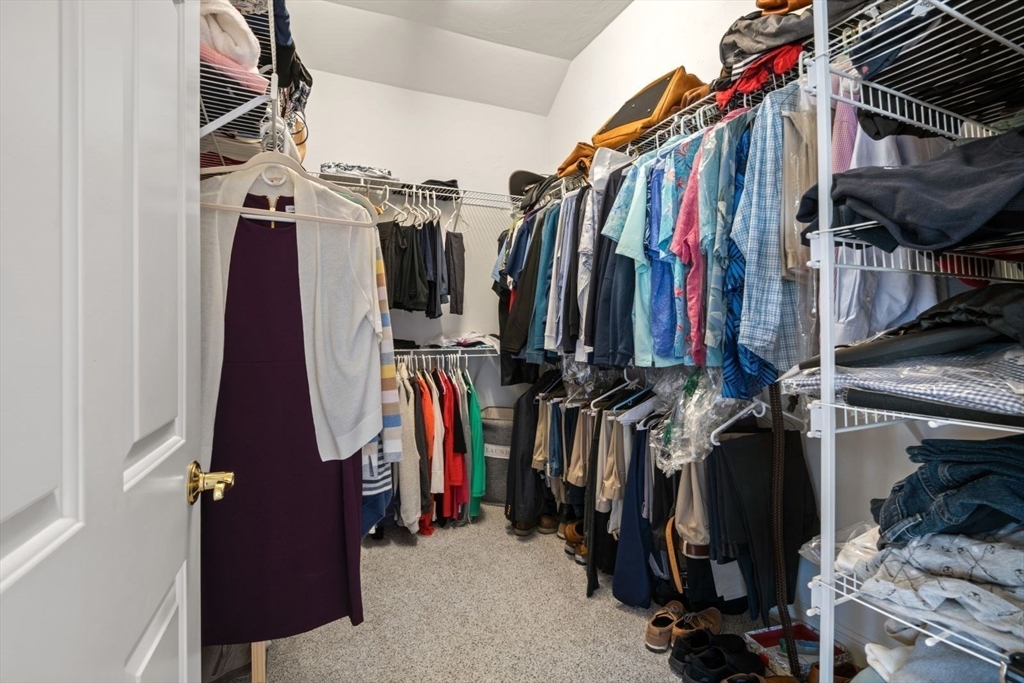101 Tussock Brook Road, Unit 101 Duxbury, MA 02332 - Photo 19 of 38 a view of walk in closet with clothes and shoes