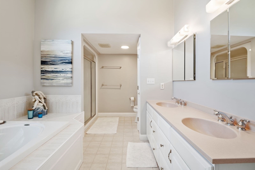 101 Tussock Brook Road, Unit 101 Duxbury, MA 02332 - Photo 20 of 38 a spacious bathroom with a tub sink and mirror