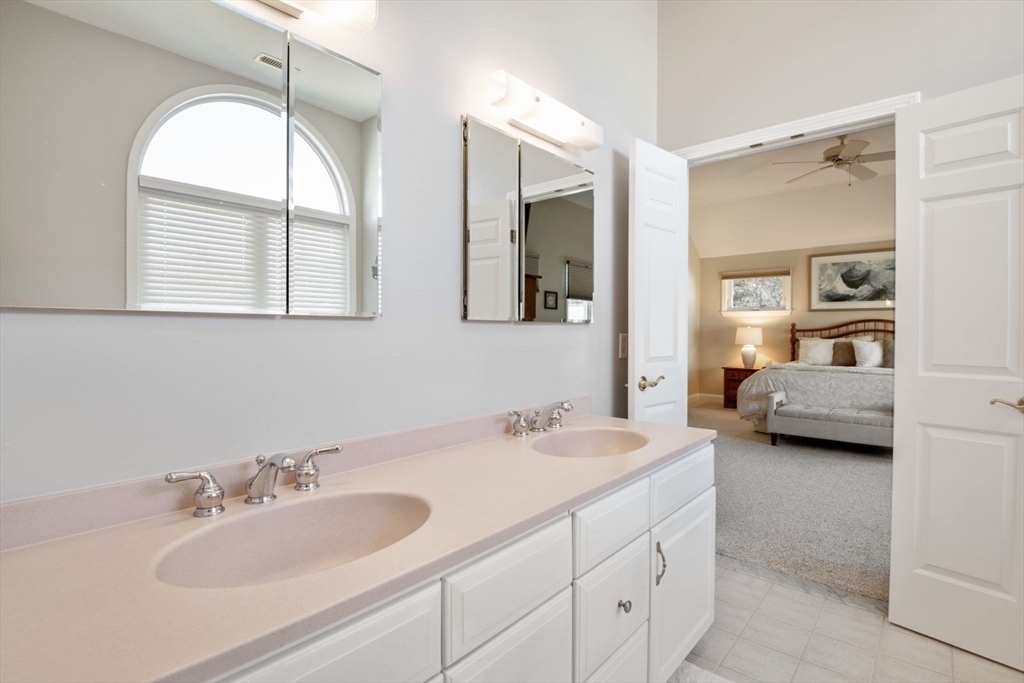 101 Tussock Brook Road, Unit 101 Duxbury, MA 02332 - Photo 21 of 38 a en suite bathroom with a double vanity sink and a mirror