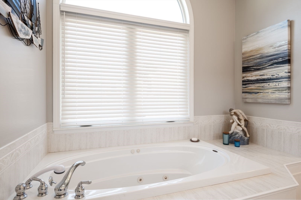 101 Tussock Brook Road, Unit 101 Duxbury, MA 02332 - Photo 22 of 38 a bathroom with a bathtub and a window