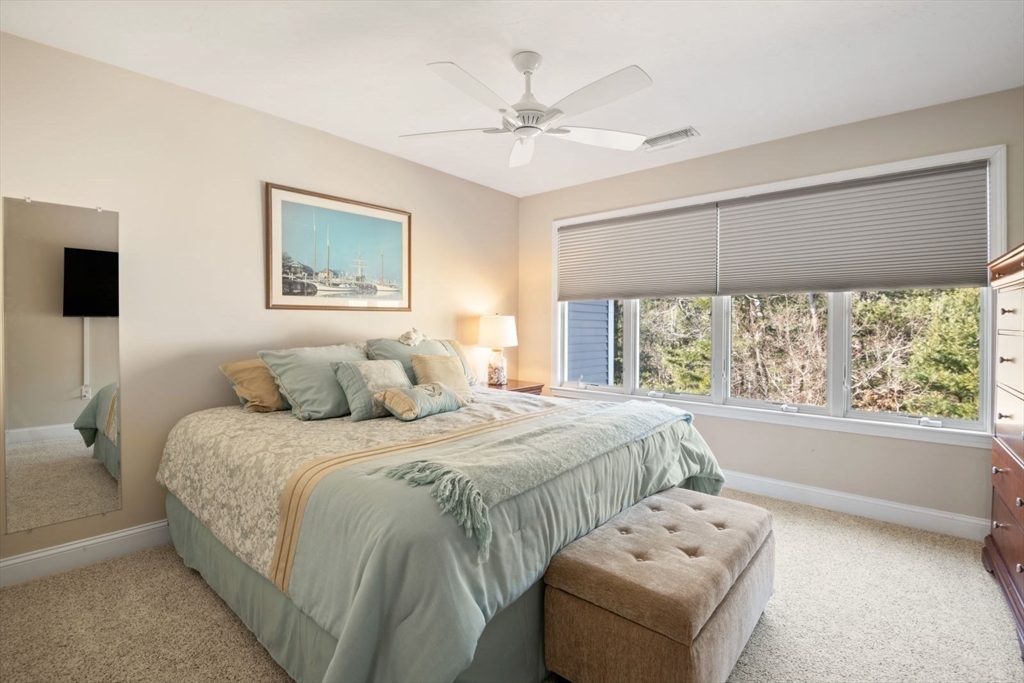 101 Tussock Brook Road, Unit 101 Duxbury, MA 02332 - Photo 23 of 38 a bedroom with a large bed and a window