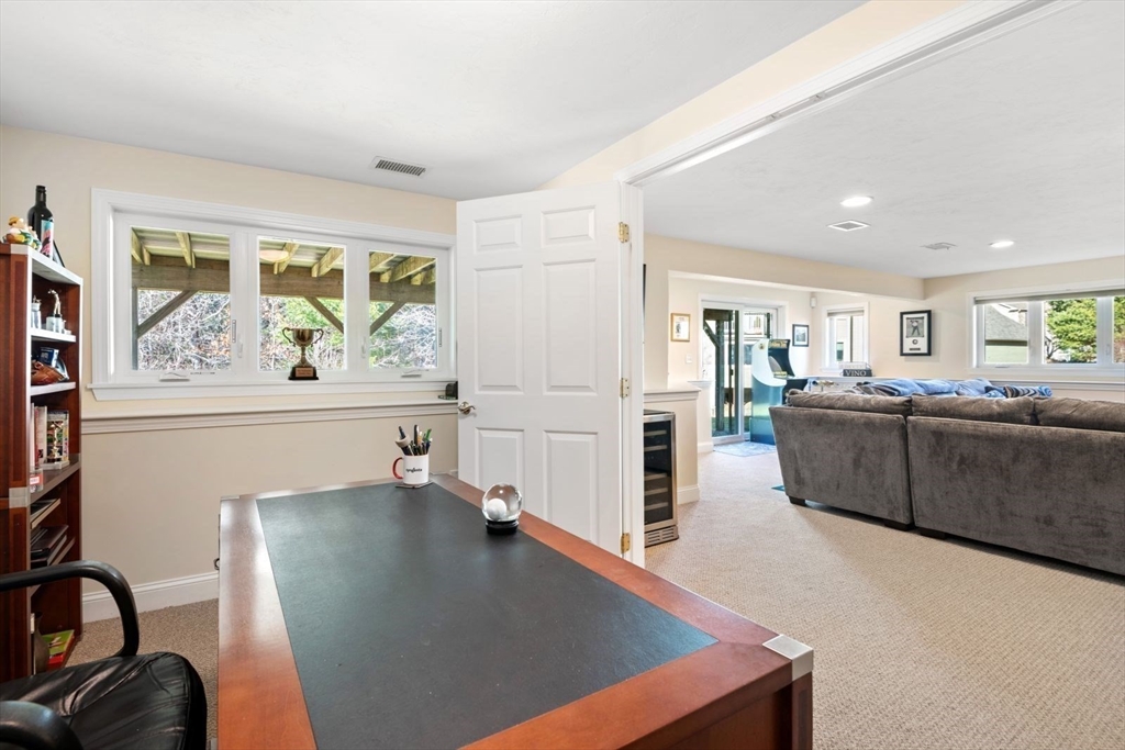 101 Tussock Brook Road, Unit 101 Duxbury, MA 02332 - Photo 27 of 38 a living room with furniture stove and a large window