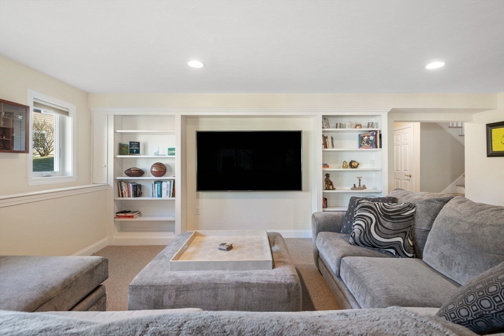 101 Tussock Brook Road, Unit 101 Duxbury, MA 02332 - Photo 28 of 38 a living room with furniture and a flat screen tv