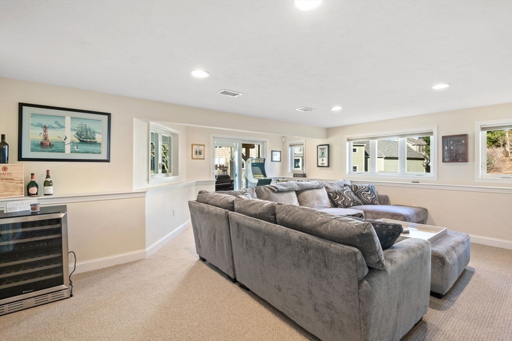 101 Tussock Brook Road, Unit 101 Duxbury, MA 02332 - Photo 30 of 38 a living room with furniture and a flat screen tv