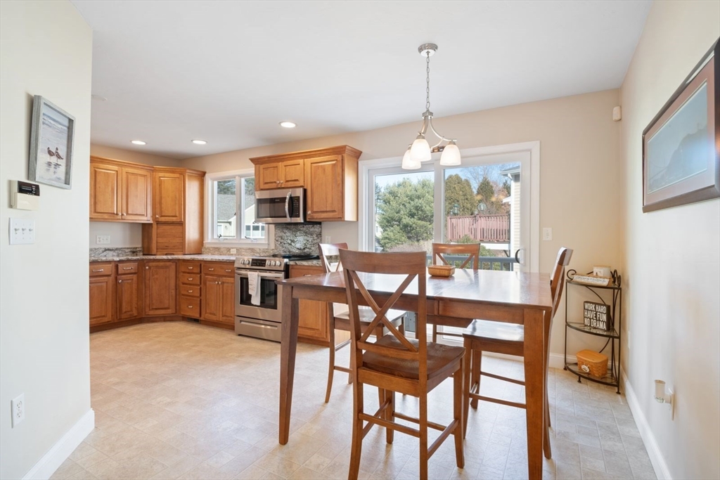 101 Tussock Brook Road, Unit 101 Duxbury, MA 02332 - Photo 3 of 38 a view of a dining room and livingroom with furniture wooden floor a chandelier