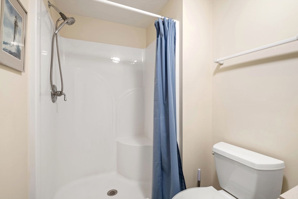 101 Tussock Brook Road, Unit 101 Duxbury, MA 02332 - Photo 33 of 38 a white toilet sitting next to a shower