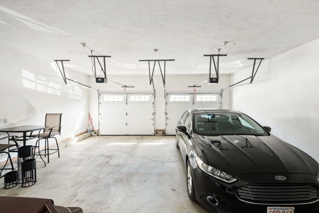 101 Tussock Brook Road, Unit 101 Duxbury, MA 02332 - Photo 34 of 38 a car parked in parking garage