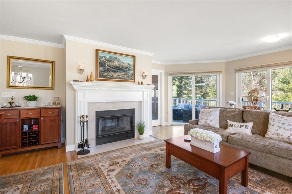 101 Tussock Brook Road, Unit 101 Duxbury, MA 02332 - Photo 9 of 38 a living room with furniture and a fireplace
