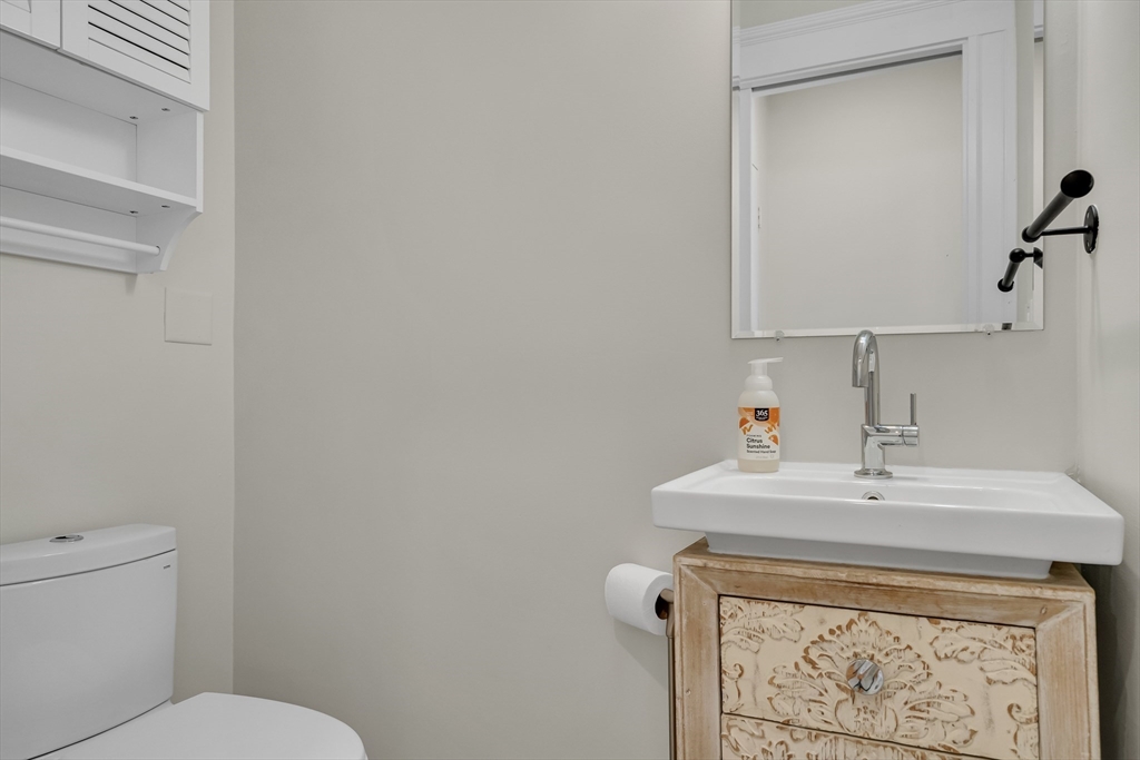 10 Dexter Road Lexington, MA 02420 - Photo 20 of 35 a bathroom with a sink a toilet and mirror