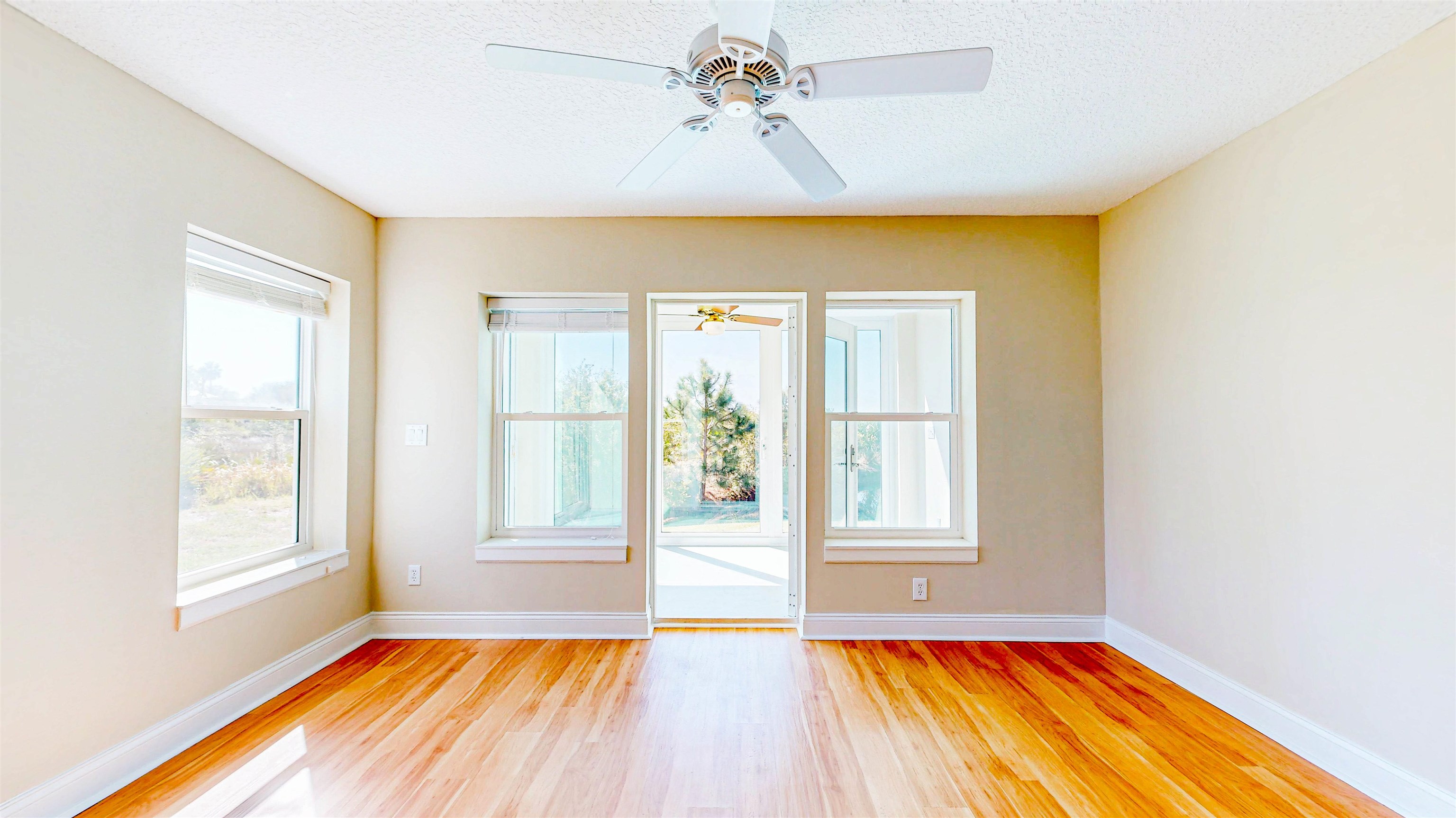 213 Sunset Point St. Augustine, FL 32080 - Photo 22 of 37 a view of an empty room with a window and wooden floor