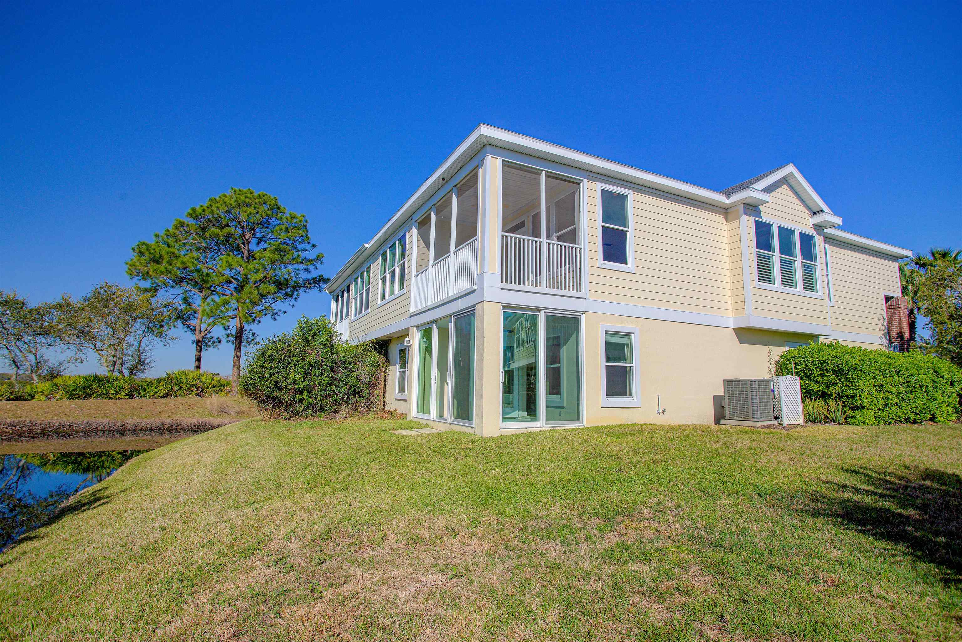 213 Sunset Point St. Augustine, FL 32080 - Photo 3 of 37 a front view of a house with a yard
