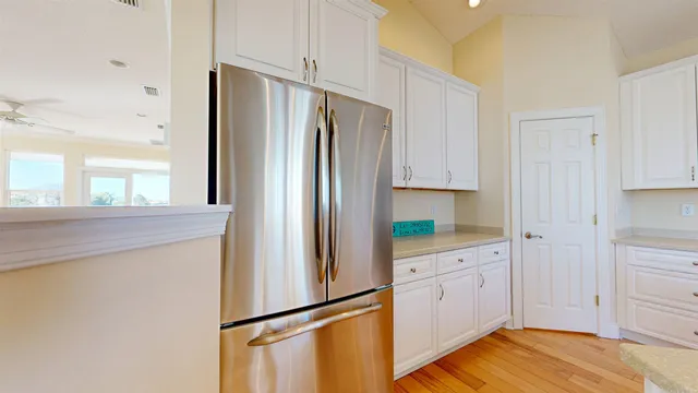 a kitchen with granite countertop white cabinets and a stove with a sink