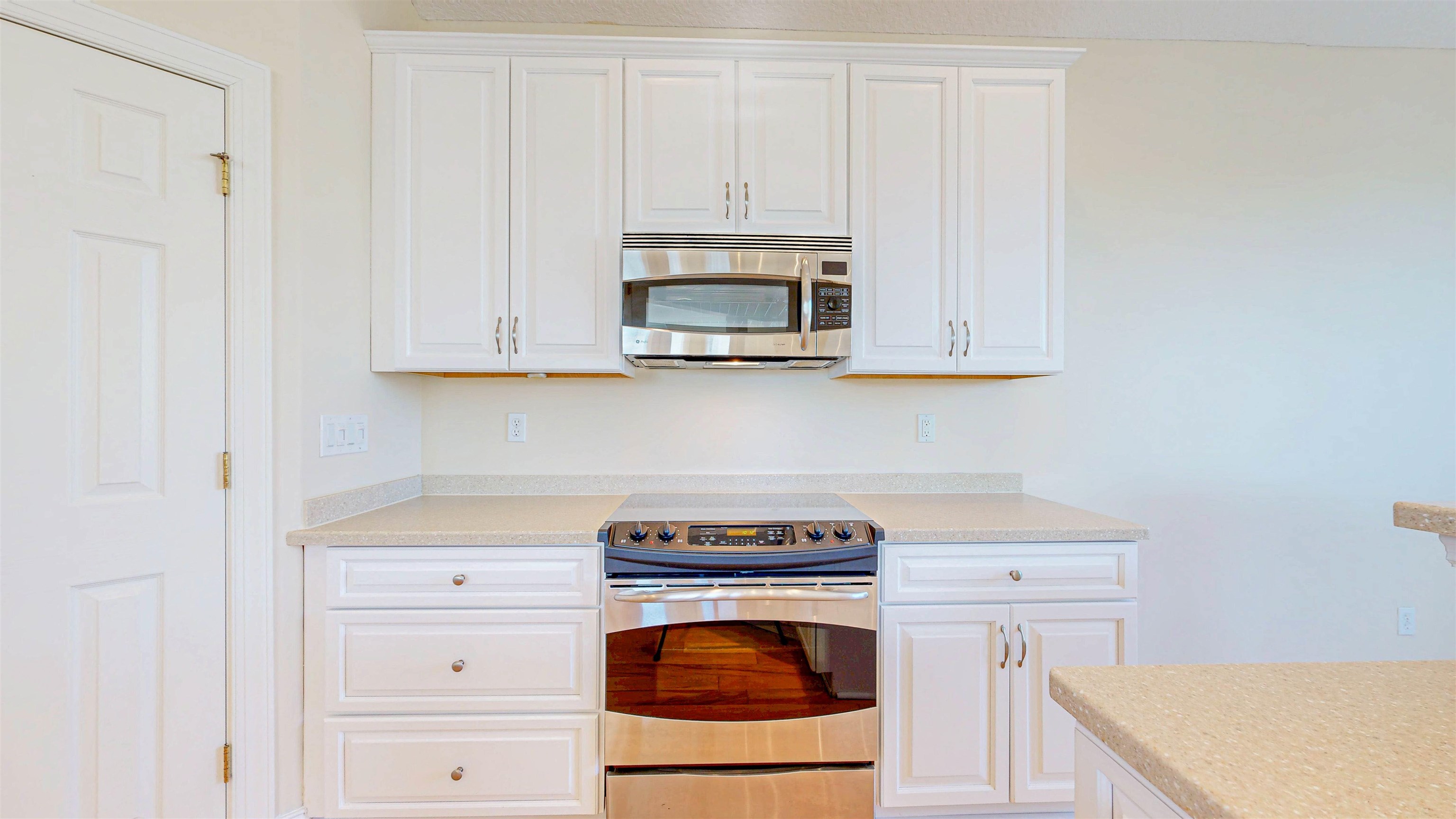 213 Sunset Point St. Augustine, FL 32080 - Photo 10 of 37 a kitchen with granite countertop white cabinets and a stove with a sink