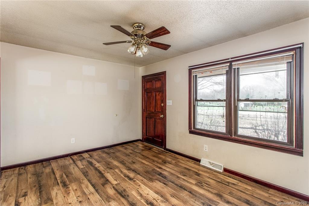 1314 Love Road Monroe, NC 28110 - Photo 14 of 36 a view of an empty room with a window and wooden floor