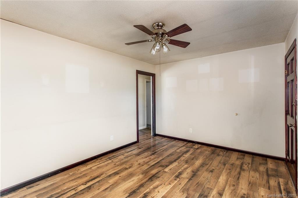 1314 Love Road Monroe, NC 28110 - Photo 15 of 36 a view of an empty room with wooden floor and a window