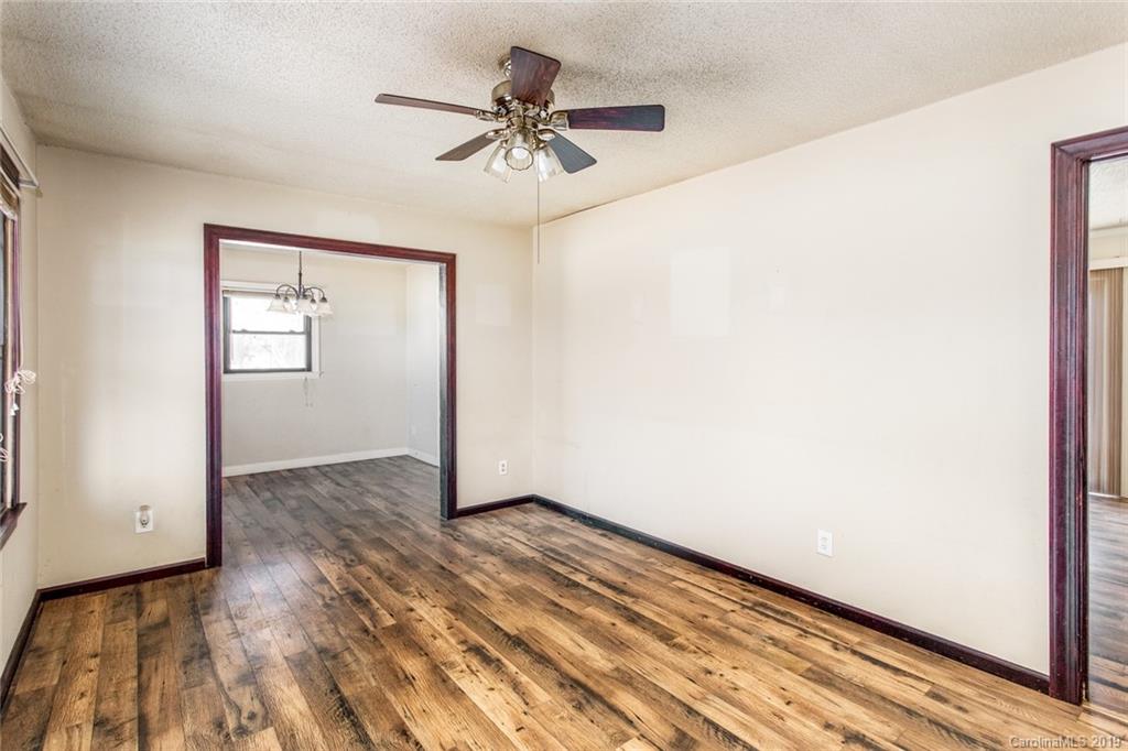 1314 Love Road Monroe, NC 28110 - Photo 16 of 36 an empty room with wooden floor closet and fan