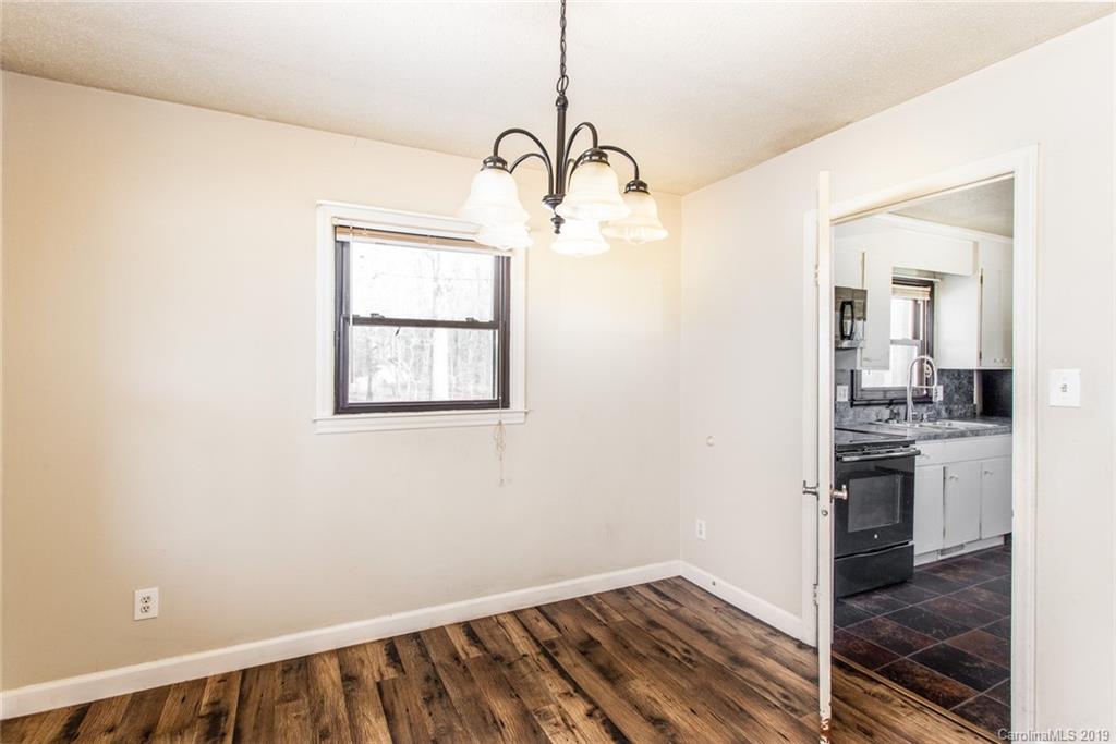 1314 Love Road Monroe, NC 28110 - Photo 20 of 36 a view hallway with wooden floor and a cabinet