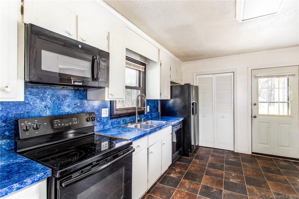 1314 Love Road Monroe, NC 28110 - Photo 23 of 36 a kitchen with a stove and a microwave