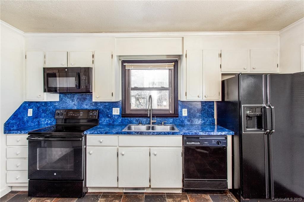 1314 Love Road Monroe, NC 28110 - Photo 24 of 36 a kitchen with stainless steel appliances granite countertop a stove a refrigerator and a microwave
