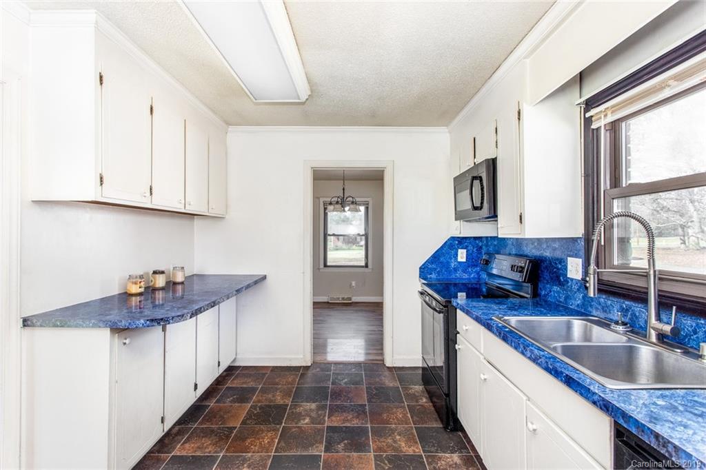 1314 Love Road Monroe, NC 28110 - Photo 25 of 36 a kitchen with stainless steel appliances granite countertop a sink stove and cabinets