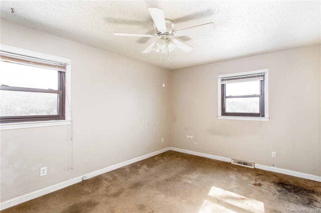 1314 Love Road Monroe, NC 28110 - Photo 29 of 36 an empty room with a window and a ceiling fan