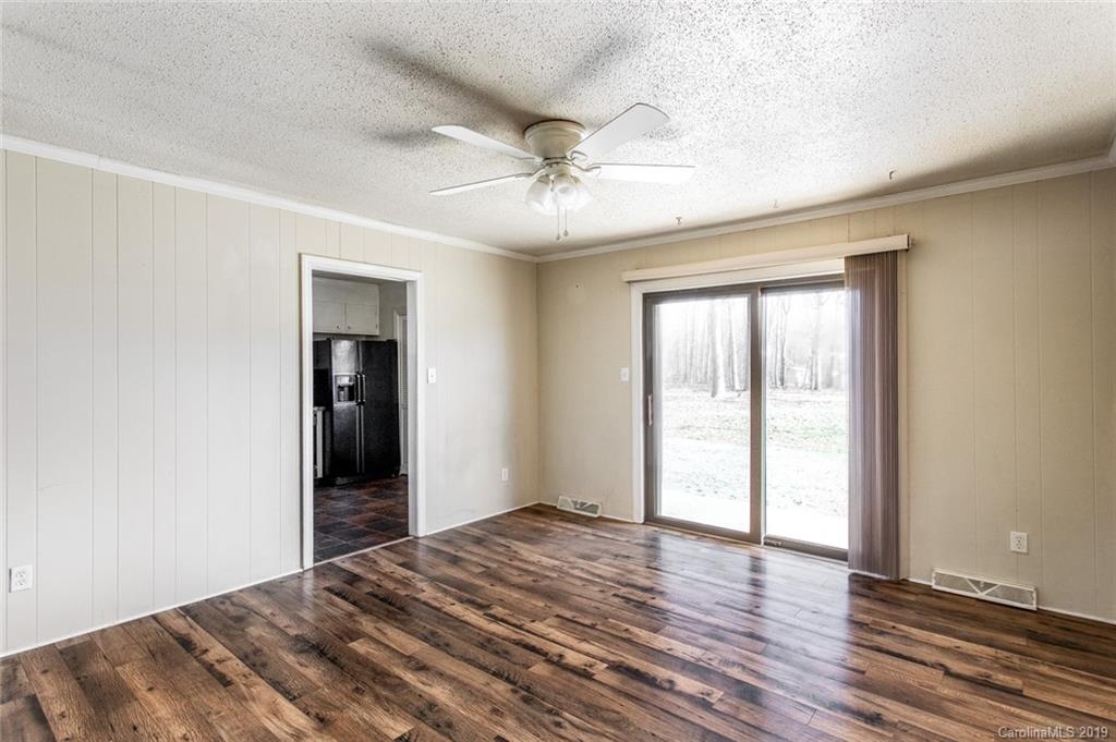 1314 Love Road Monroe, NC 28110 - Photo 10 of 36 a view of an empty room with wooden floor and a window