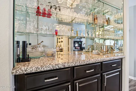 a kitchen with granite countertop lots of wooden cabinets and appliances