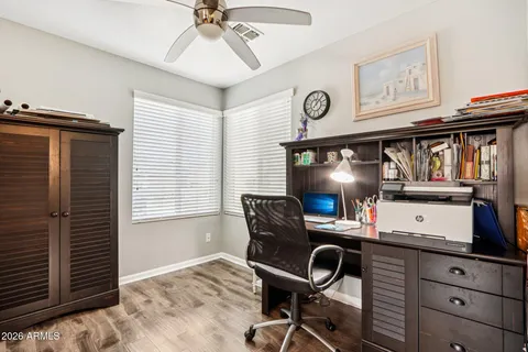 a view of a workspace with furniture and a window