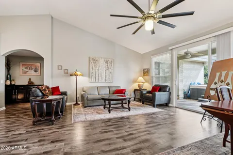 a living room with furniture and a wooden floor