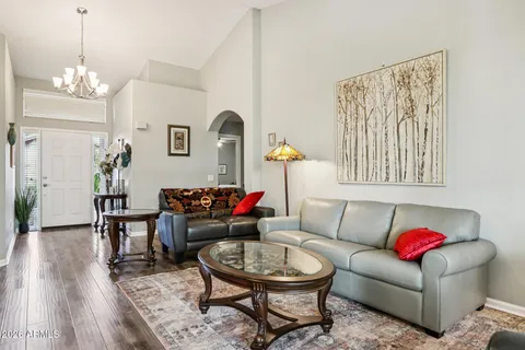 a living room with furniture a rug and a chandelier