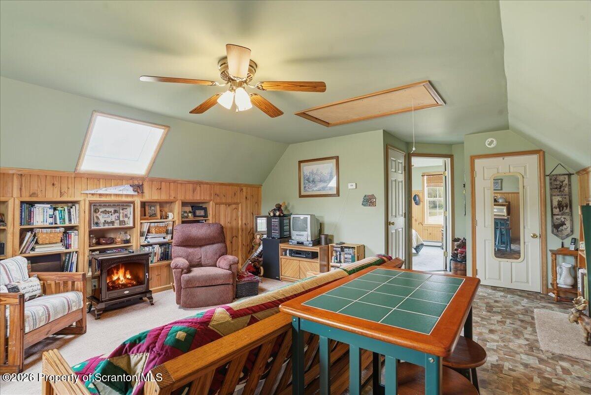 5231 Fiddle Lake Road Thompson, PA 18465 - Photo 16 of 34 a living room with furniture a rug and a chandelier