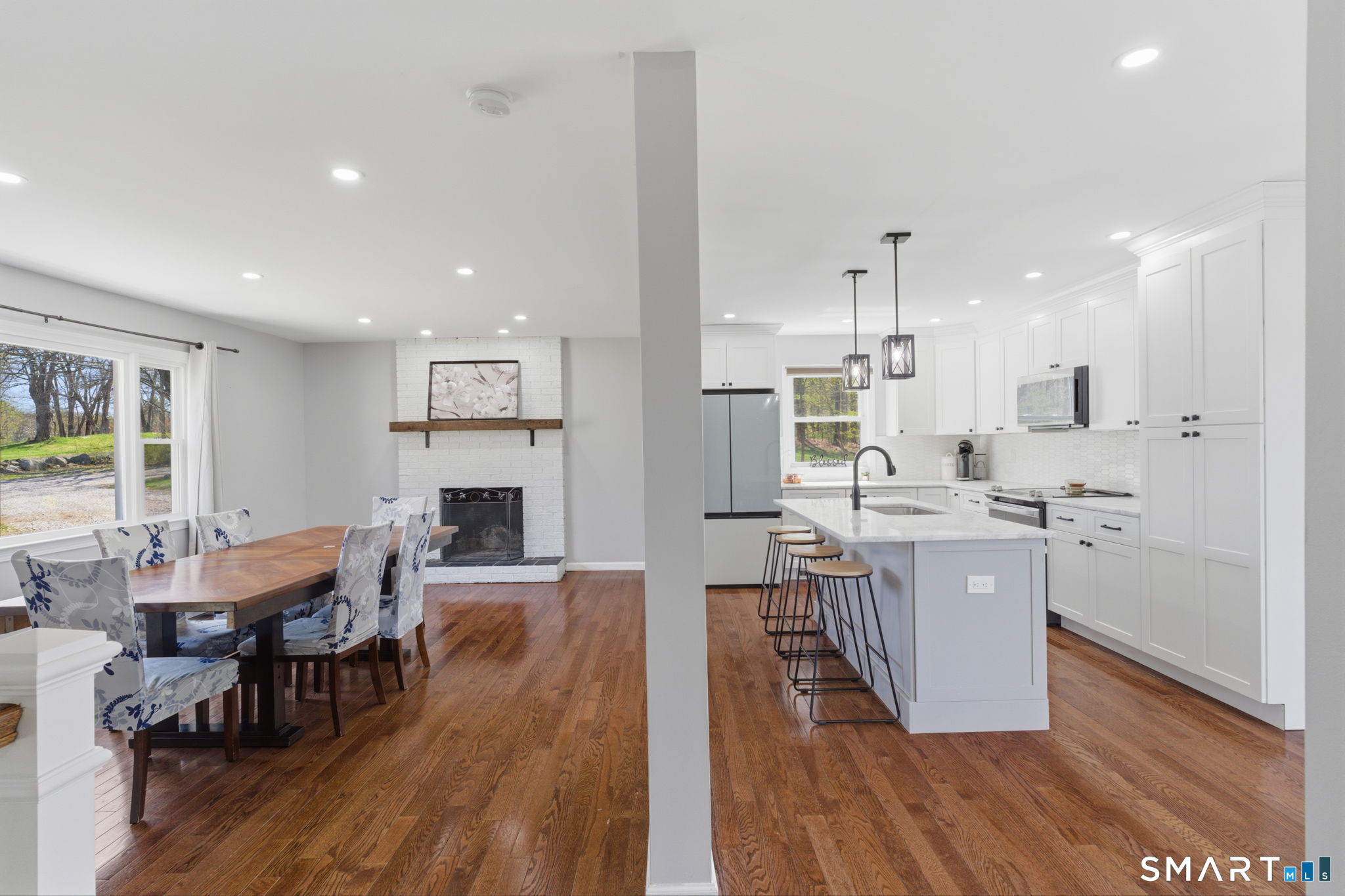 99 West Chippens Hill Road Burlington, CT 06013 - Photo 15 of 40 a kitchen with stainless steel appliances granite countertop a table chairs stove a sink dishwasher a refrigerator and cabinets with wooden floor
