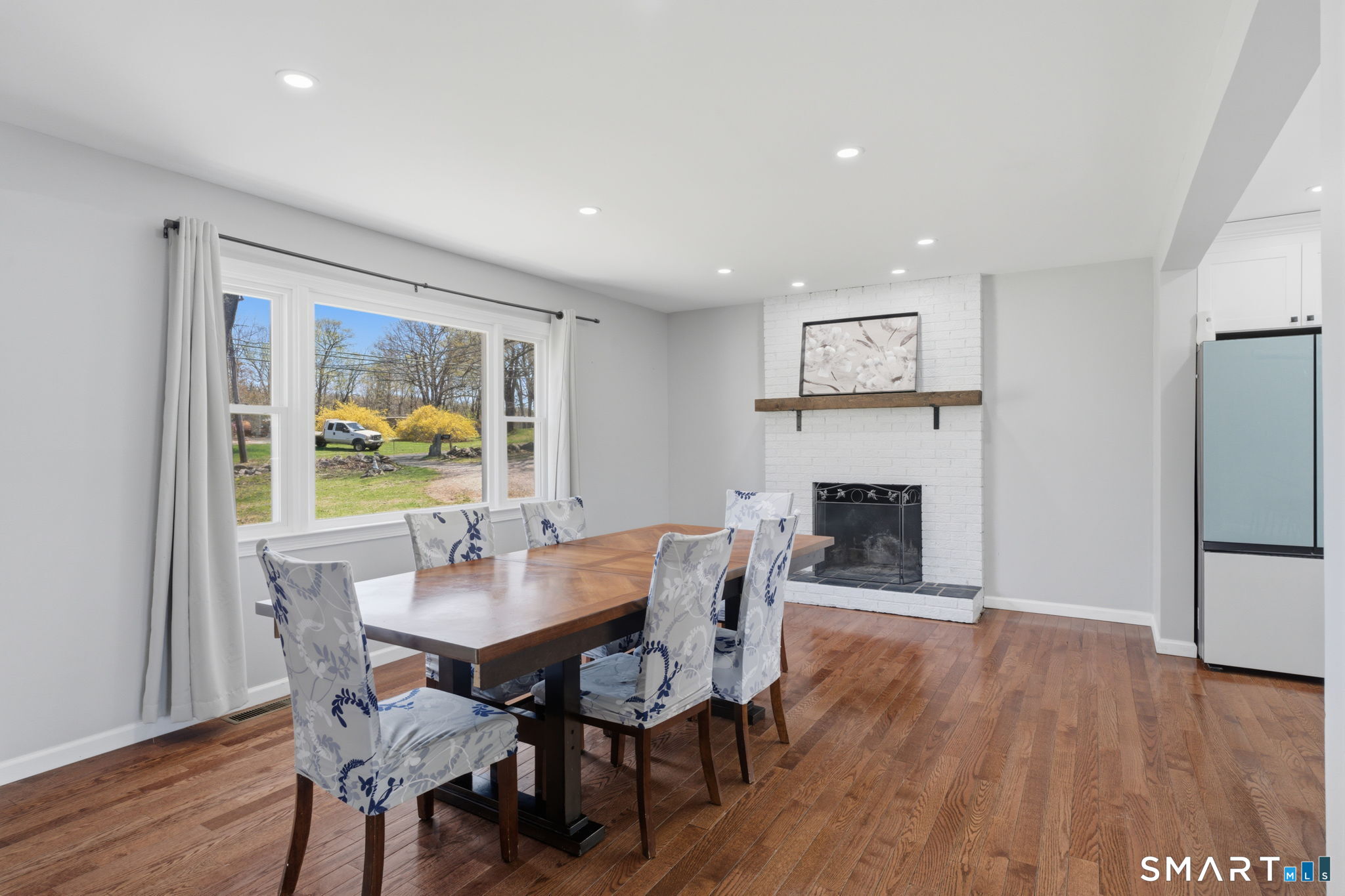 99 West Chippens Hill Road Burlington, CT 06013 - Photo 16 of 40 a dining room with furniture a fireplace and wooden floor