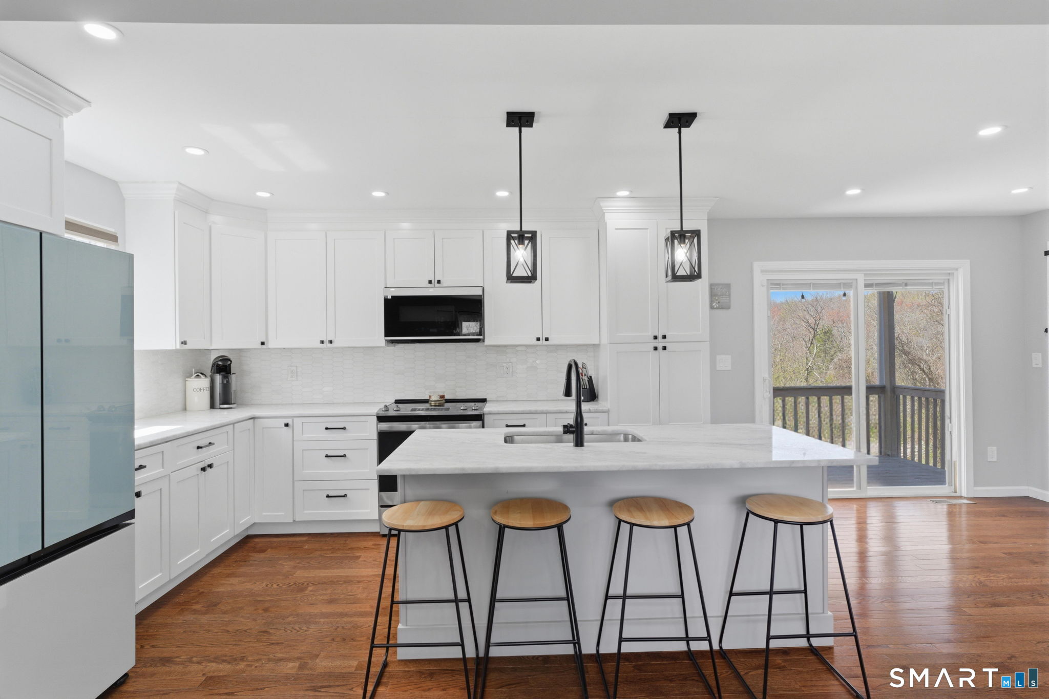 99 West Chippens Hill Road Burlington, CT 06013 - Photo 18 of 40 a kitchen with stainless steel appliances kitchen island granite countertop a dining table chairs sink and cabinets