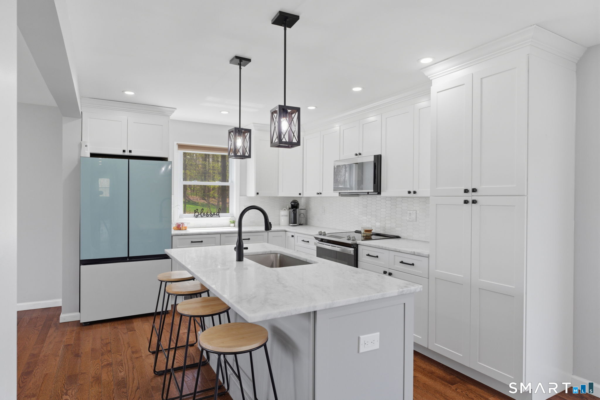 99 West Chippens Hill Road Burlington, CT 06013 - Photo 19 of 40 a kitchen with a sink a refrigerator and chairs