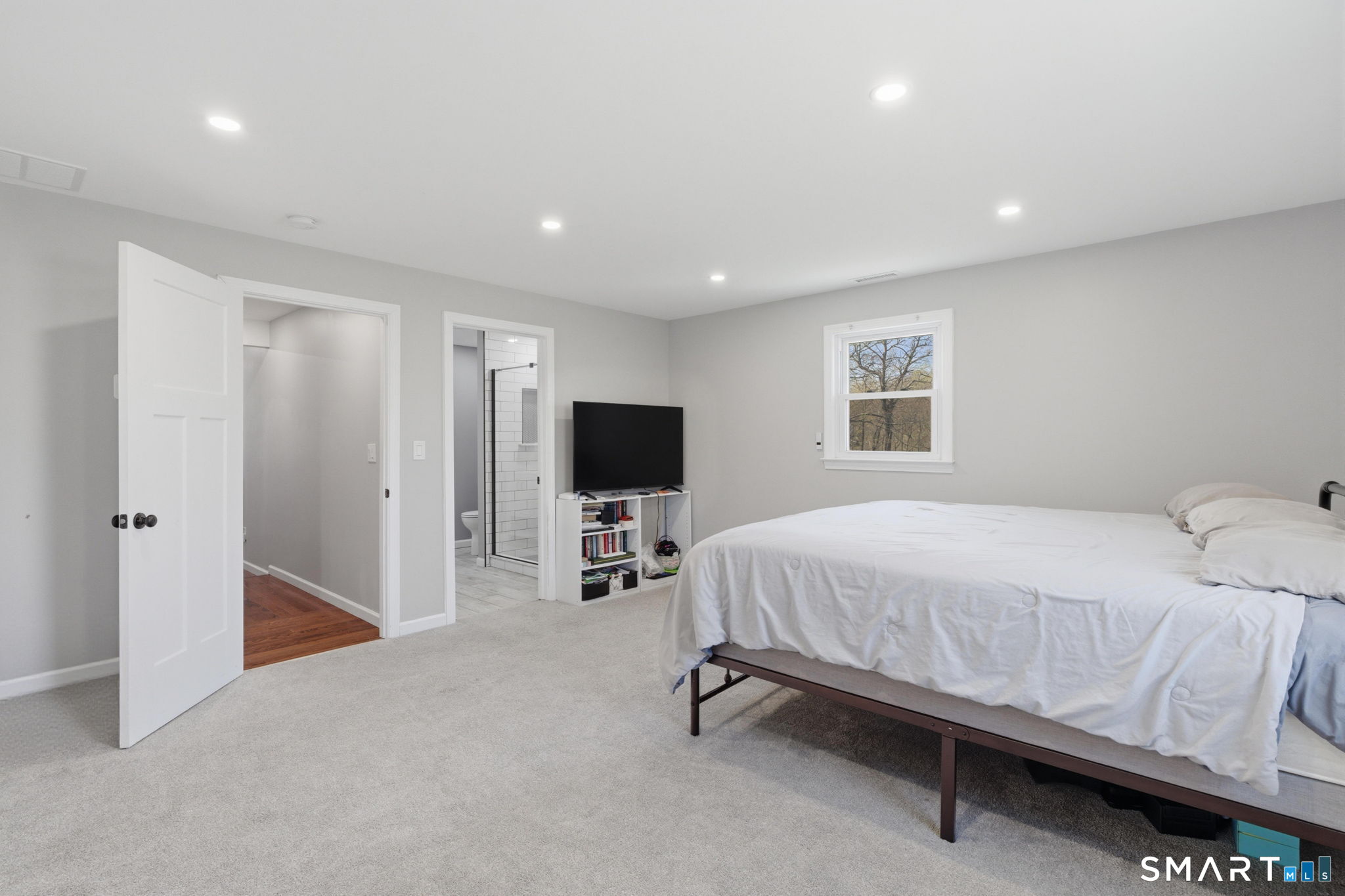 99 West Chippens Hill Road Burlington, CT 06013 - Photo 27 of 40 a spacious bedroom with a bed and a flat screen tv