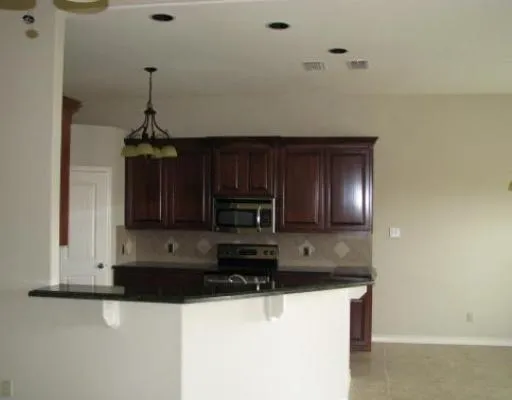 a view of a kitchen with electric appliances