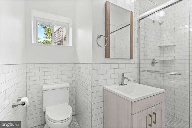 a bathroom with a sink a toilet and a shower