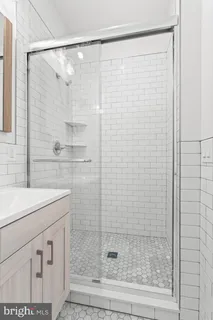 a bathroom with a shower and a sink